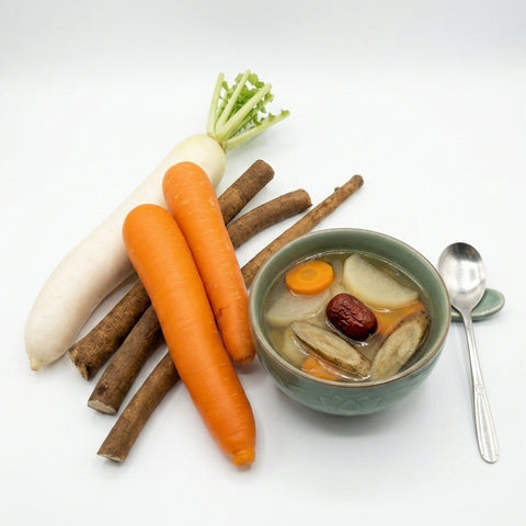 A bowl of herbal soup with carrots, daikon radish, cinnamon sticks, and a red date, styled with a spoon on a clean white background.